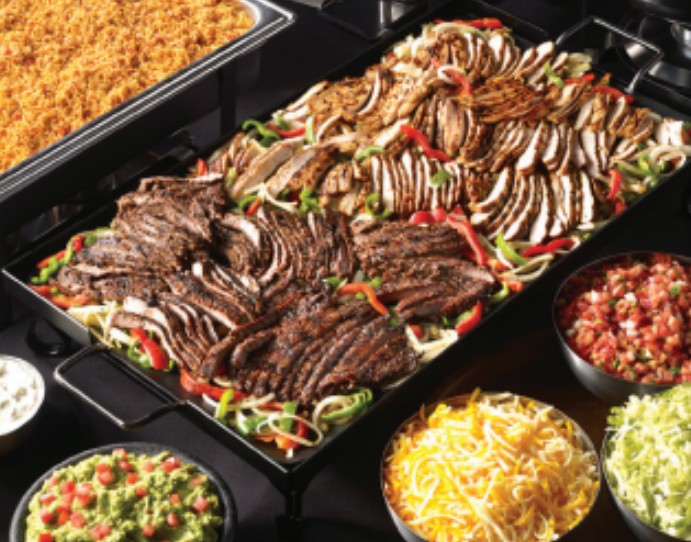 Chuy's nacho bar with chips, queso, and creamy jalapeño for a budget office lunch