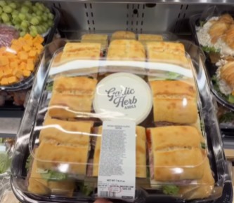 Costco Business Delivery cases of bulk beverages and snacks staged for an office
